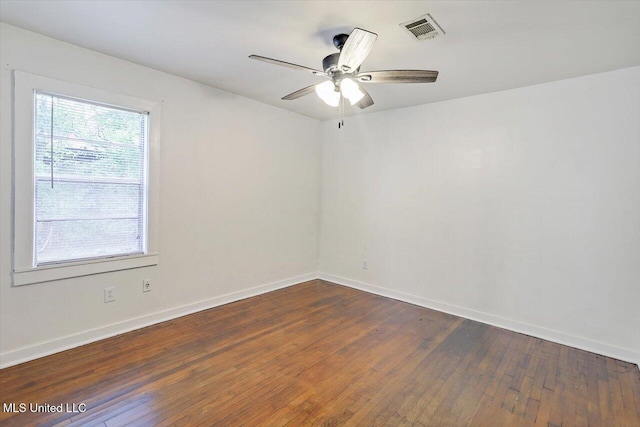 722 SE 1st St, Magee, MS 39111 - spare room featuring baseboards, a ceiling fan, dark wood-style floors, and visible vents