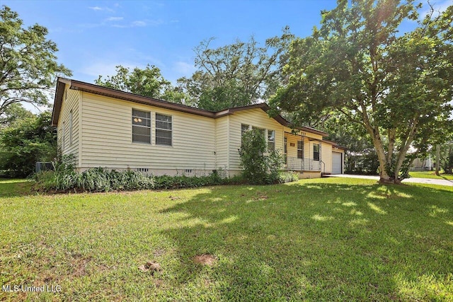 722 SE 1st St, Magee, MS 39111 - view of front of property featuring a garage, a front lawn, and crawl space
