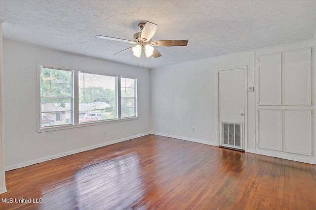 722 SE 1st St, Magee, MS 39111 - spare room featuring baseboards, a textured ceiling, visible vents, and wood finished floors