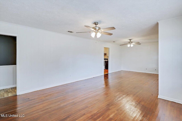 722 SE 1st St, Magee, MS 39111 - empty room featuring visible vents, wood finished floors, baseboards, ceiling fan, and a textured ceiling