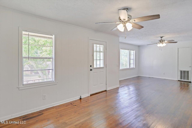 722 SE 1st St, Magee, MS 39111 - foyer with wood finished floors, ceiling fan, a textured ceiling, and visible vents