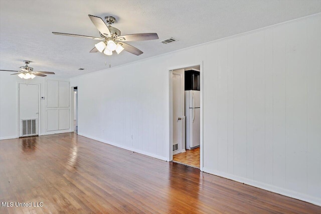 722 SE 1st St, Magee, MS 39111 - spare room with visible vents, a textured ceiling, ceiling fan, and wood finished floors