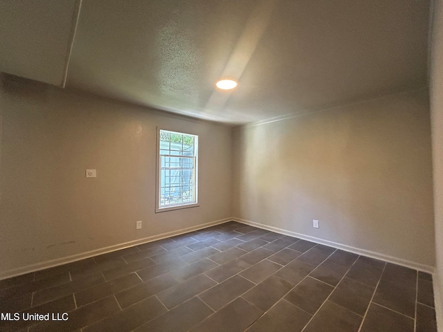 unfurnished room featuring a textured ceiling