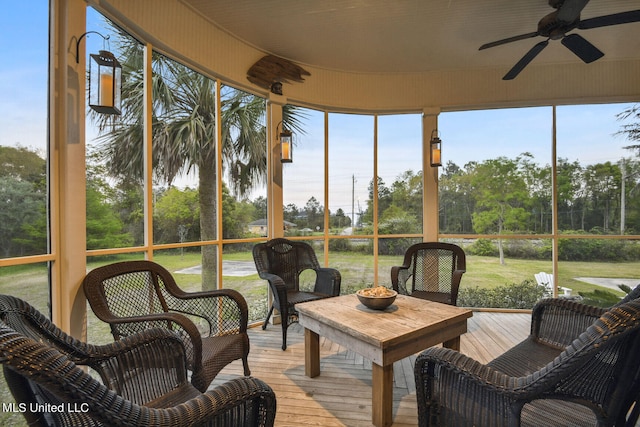 sunroom / solarium featuring ceiling fan