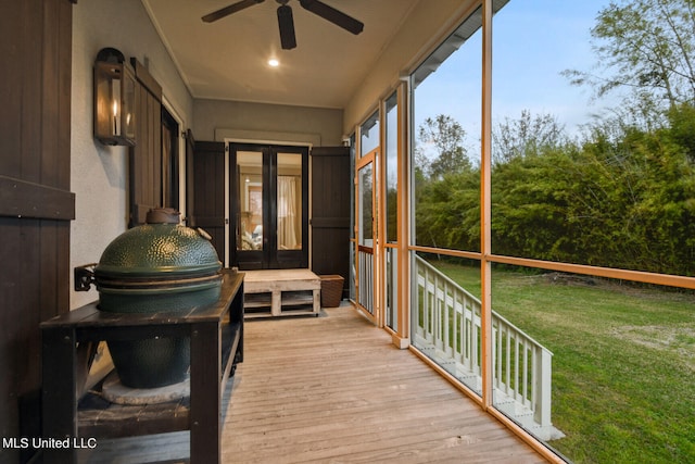 sunroom featuring ceiling fan