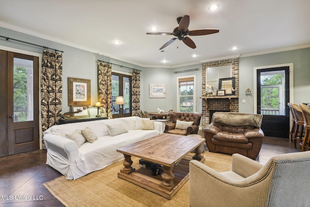 living room featuring ornamental molding, plenty of natural light, and ceiling fan