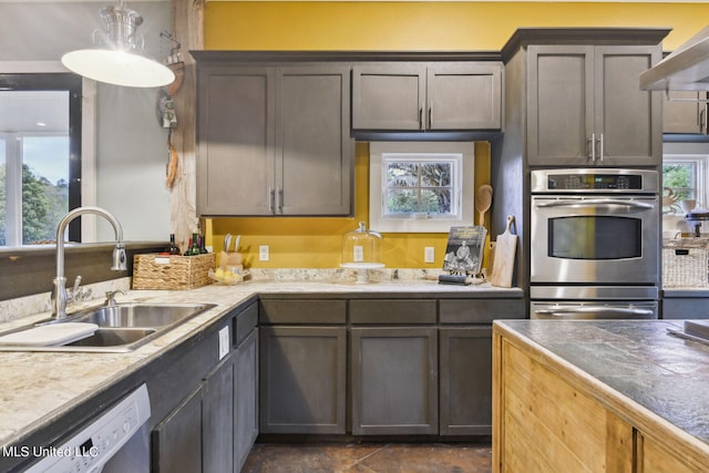 kitchen with a wealth of natural light, sink, dishwashing machine, and stainless steel double oven