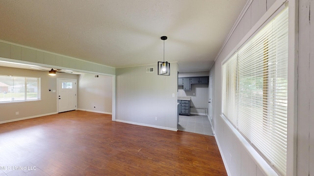 1384 Whitworth Cv, Southaven, MS 38671 - unfurnished dining area featuring ornamental molding, wood finished floors, a ceiling fan, baseboards, and a textured ceiling