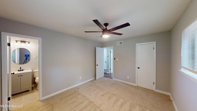 1384 Whitworth Cv, Southaven, MS 38671 - unfurnished bedroom with baseboards, light colored carpet, ensuite bath, and a ceiling fan