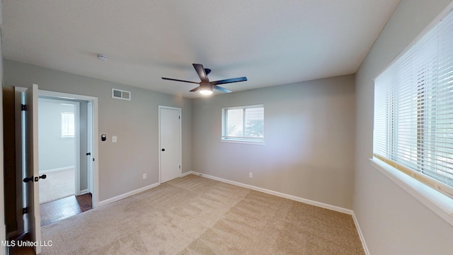 1384 Whitworth Cv, Southaven, MS 38671 - unfurnished bedroom with light colored carpet, baseboards, and ceiling fan