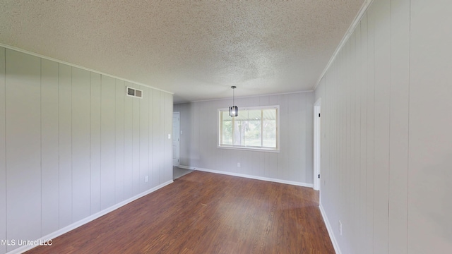 1384 Whitworth Cv, Southaven, MS 38671 - unfurnished room featuring dark wood finished floors, a textured ceiling, crown molding, and baseboards