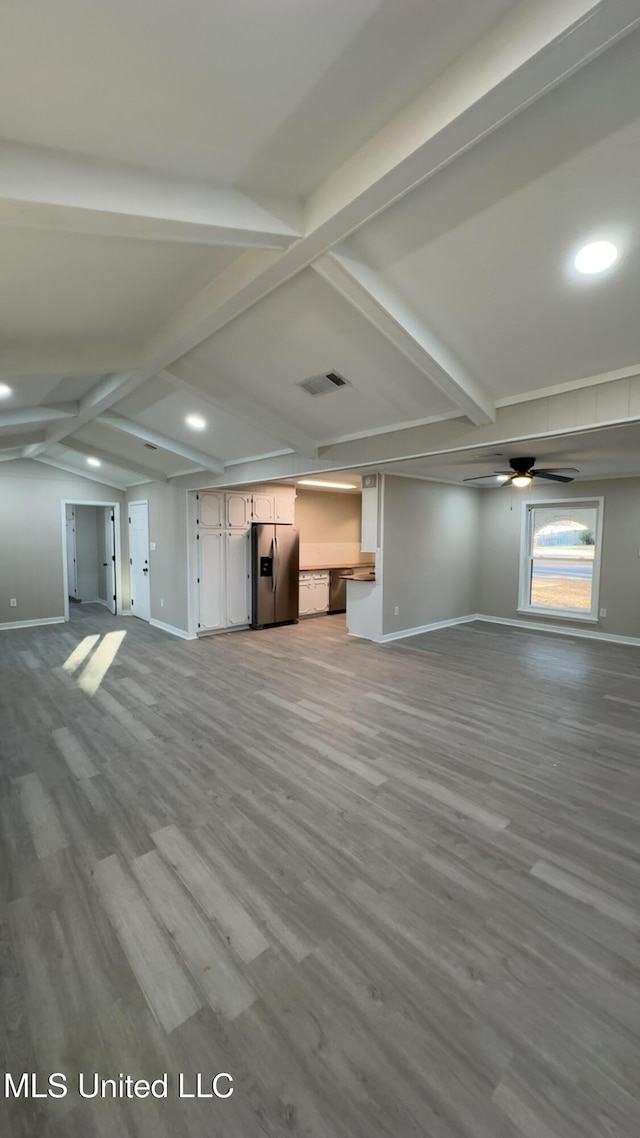 unfurnished living room with visible vents, ceiling fan, baseboards, and wood finished floors