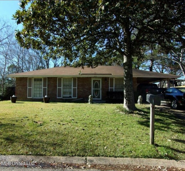 view of front facade featuring a front lawn and an attached carport