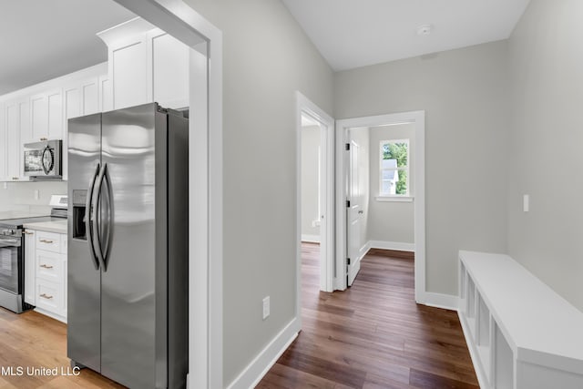 13379 Wash Fayard Rd, Biloxi, MS 39532 - kitchen featuring stainless steel appliances, white cabinets, light countertops, and dark wood finished floors