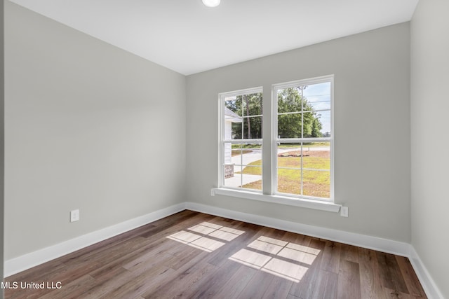 13379 Wash Fayard Rd, Biloxi, MS 39532 - spare room with healthy amount of natural light, baseboards, and wood finished floors