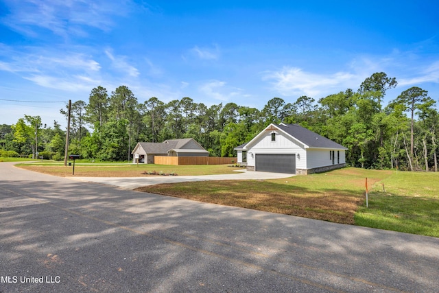 13379 Wash Fayard Rd, Biloxi, MS 39532 - view of front of house featuring driveway, board and batten siding, and view of wooded area