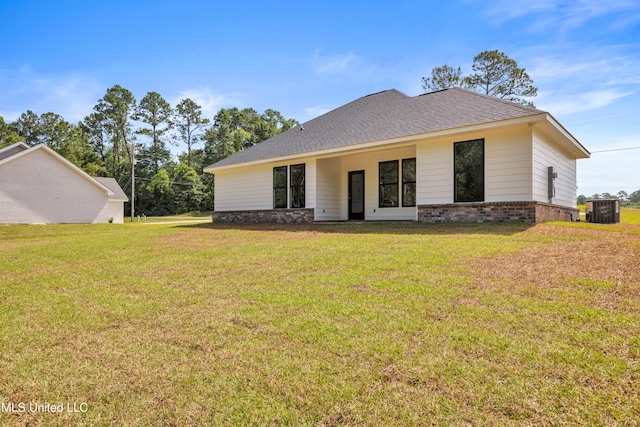 13379 Wash Fayard Rd, Biloxi, MS 39532 - view of front of house featuring brick siding, central air condition unit, a front lawn, and roof with shingles