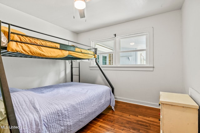 bedroom with ceiling fan and dark hardwood / wood-style flooring