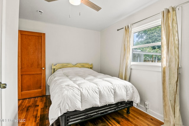 bedroom with ceiling fan and dark hardwood / wood-style flooring