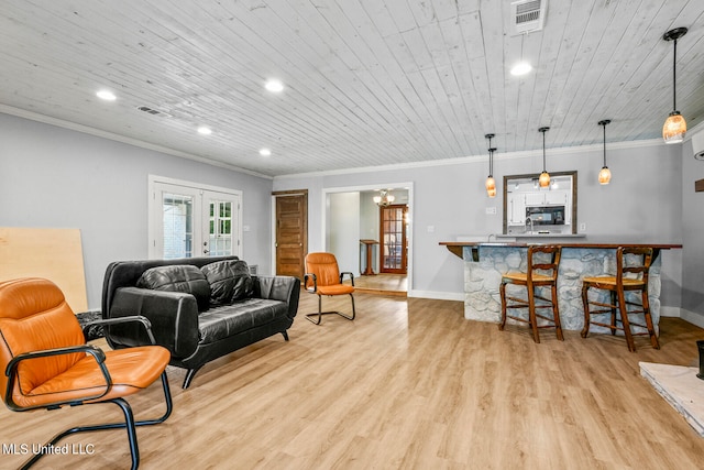 living room featuring a chandelier, wooden ceiling, crown molding, light hardwood / wood-style floors, and french doors