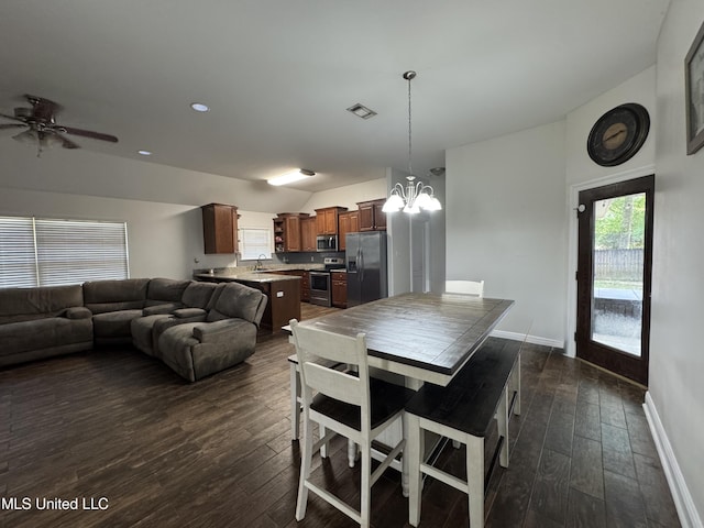 9612 Kini St, Diamondhead, MS 39525 - dining room featuring vaulted ceiling, dark wood finished floors, a chandelier, and ceiling fan
