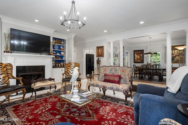 living room featuring ornate columns, a notable chandelier, and ornamental molding