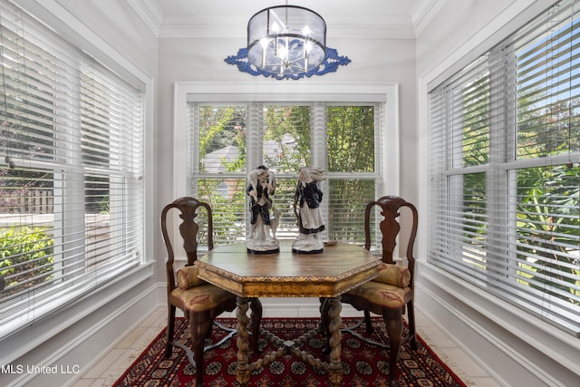 dining space featuring a wealth of natural light, crown molding, and a notable chandelier