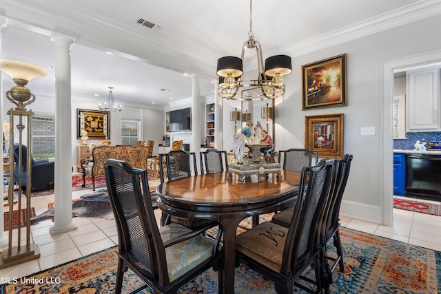 dining space featuring crown molding, ornate columns, an inviting chandelier, and light tile patterned floors