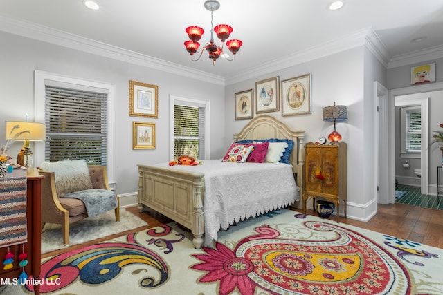 bedroom featuring ornamental molding, a notable chandelier, hardwood / wood-style flooring, and connected bathroom