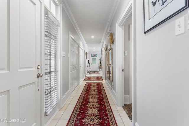 corridor featuring crown molding and light tile patterned floors