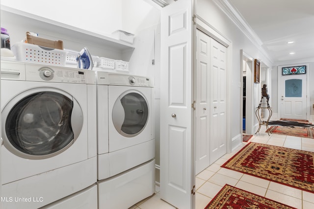 clothes washing area featuring crown molding, independent washer and dryer, and light tile patterned floors