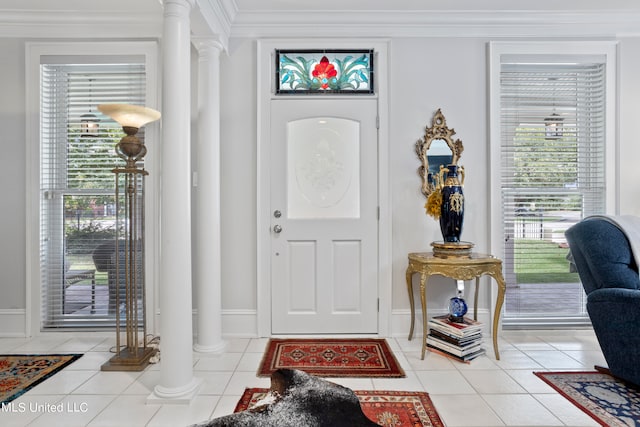 entryway featuring ornamental molding, decorative columns, and light tile patterned floors