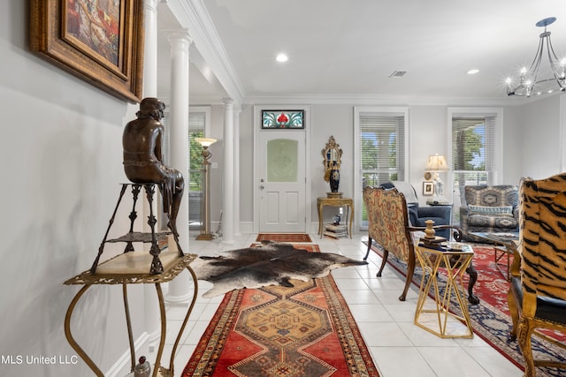 interior space with crown molding, decorative columns, and a chandelier