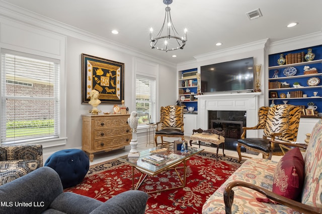 living room with a notable chandelier, plenty of natural light, and crown molding