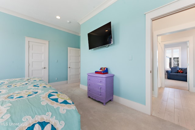 bedroom with crown molding and light hardwood / wood-style flooring