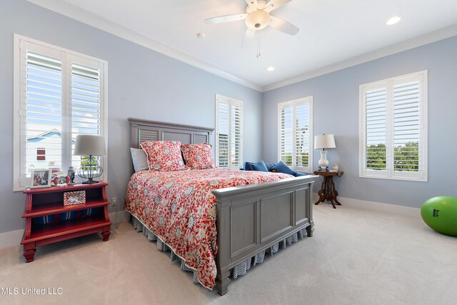 bedroom featuring light carpet, crown molding, and ceiling fan