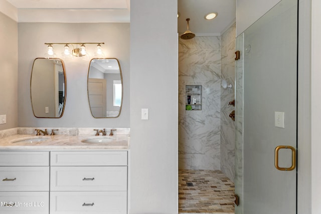 bathroom with a shower with door and vanity