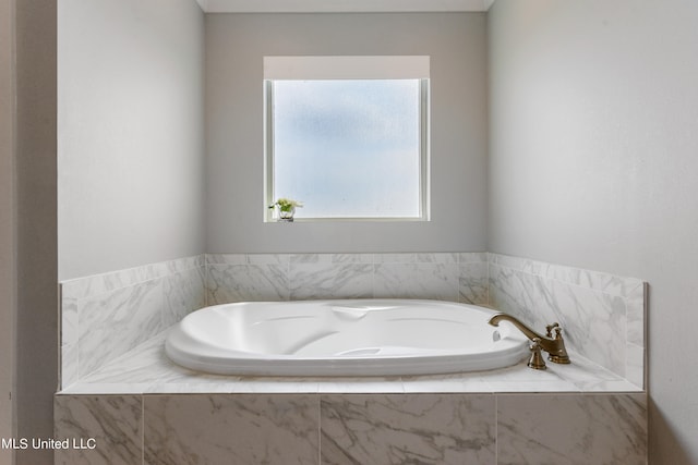 bathroom featuring tiled tub