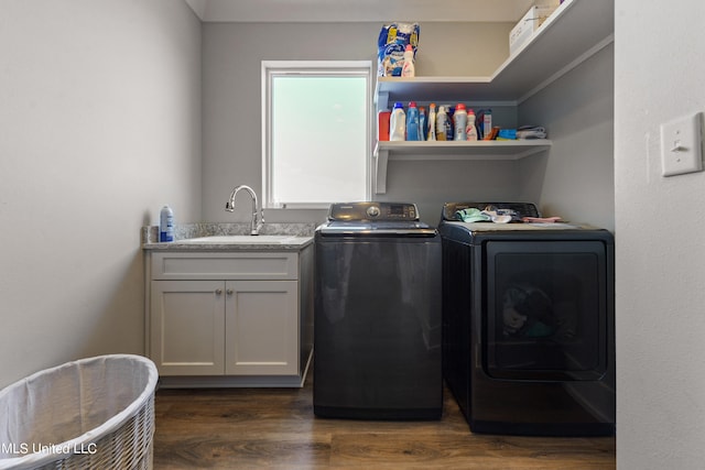 laundry room with cabinets, sink, separate washer and dryer, and dark hardwood / wood-style floors