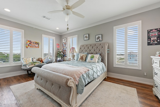 bedroom with dark wood-type flooring, ceiling fan, ornamental molding, and multiple windows