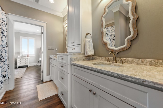 bathroom with vanity, hardwood / wood-style floors, ornamental molding, and toilet