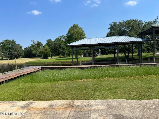 view of home's community with a water view, a gazebo, and a lawn