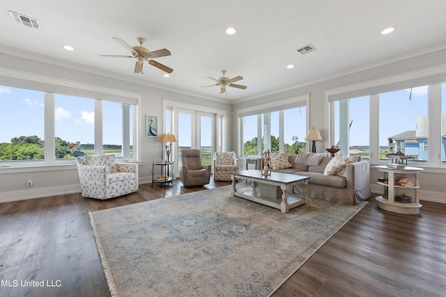 living room with ornamental molding, dark hardwood / wood-style floors, and ceiling fan