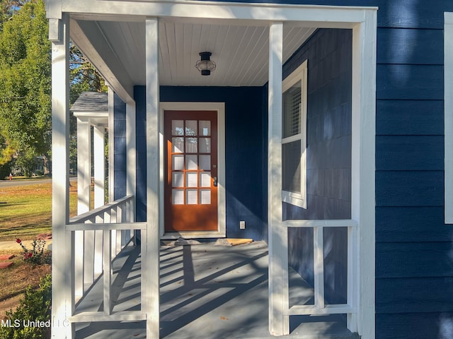 view of exterior entry featuring a porch