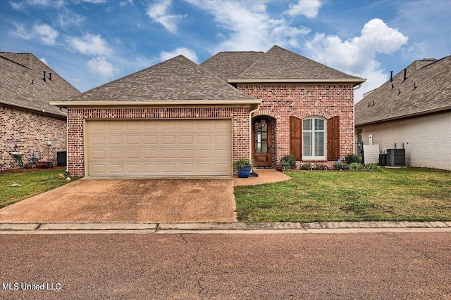 38 Savannah Cir, Brandon, MS 39047 - french country home with brick siding, driveway, a front yard, a garage, and roof with shingles