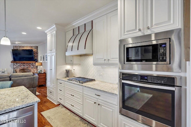 38 Savannah Cir, Brandon, MS 39047 - kitchen with appliances with stainless steel finishes, white cabinets, backsplash, recessed lighting, and crown molding