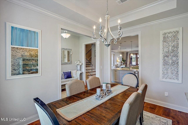 38 Savannah Cir, Brandon, MS 39047 - dining area with stairway, dark wood-type flooring, crown molding, and a chandelier