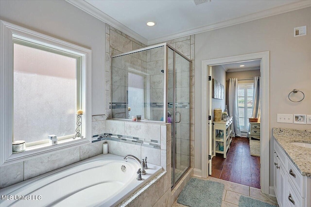 38 Savannah Cir, Brandon, MS 39047 - ensuite bathroom featuring crown molding, a garden tub, vanity, a stall shower, and recessed lighting