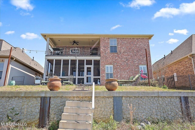38 Savannah Cir, Brandon, MS 39047 - rear view of house with a balcony, brick siding, and a sunroom