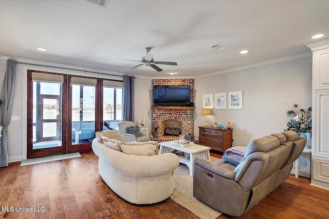 38 Savannah Cir, Brandon, MS 39047 - living area featuring crown molding, a ceiling fan, wood finished floors, recessed lighting, and a brick fireplace